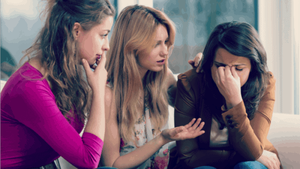 women supporting upset friend