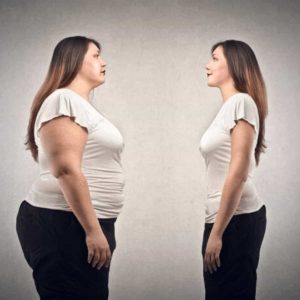 the-same-woman-in-two-different-body-sizes-staring-at-her-other-self-demonstrating-the-reality-of-distorted-postpartum-body-image