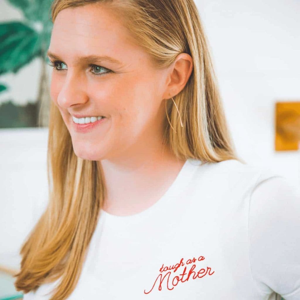 profile-view-of-blonde-woman-wearing-tshirt-that-says-tough-as-a-mother-available-for-purchase-at-the-bee-and-the-fox
