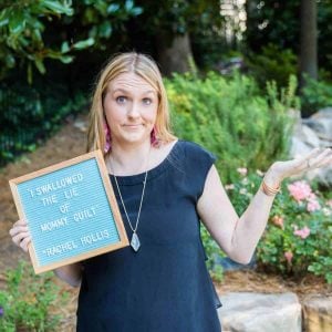 blonde woman shrugging her shoulders holding a letter board that says I swallowed the lie of mommy guilt