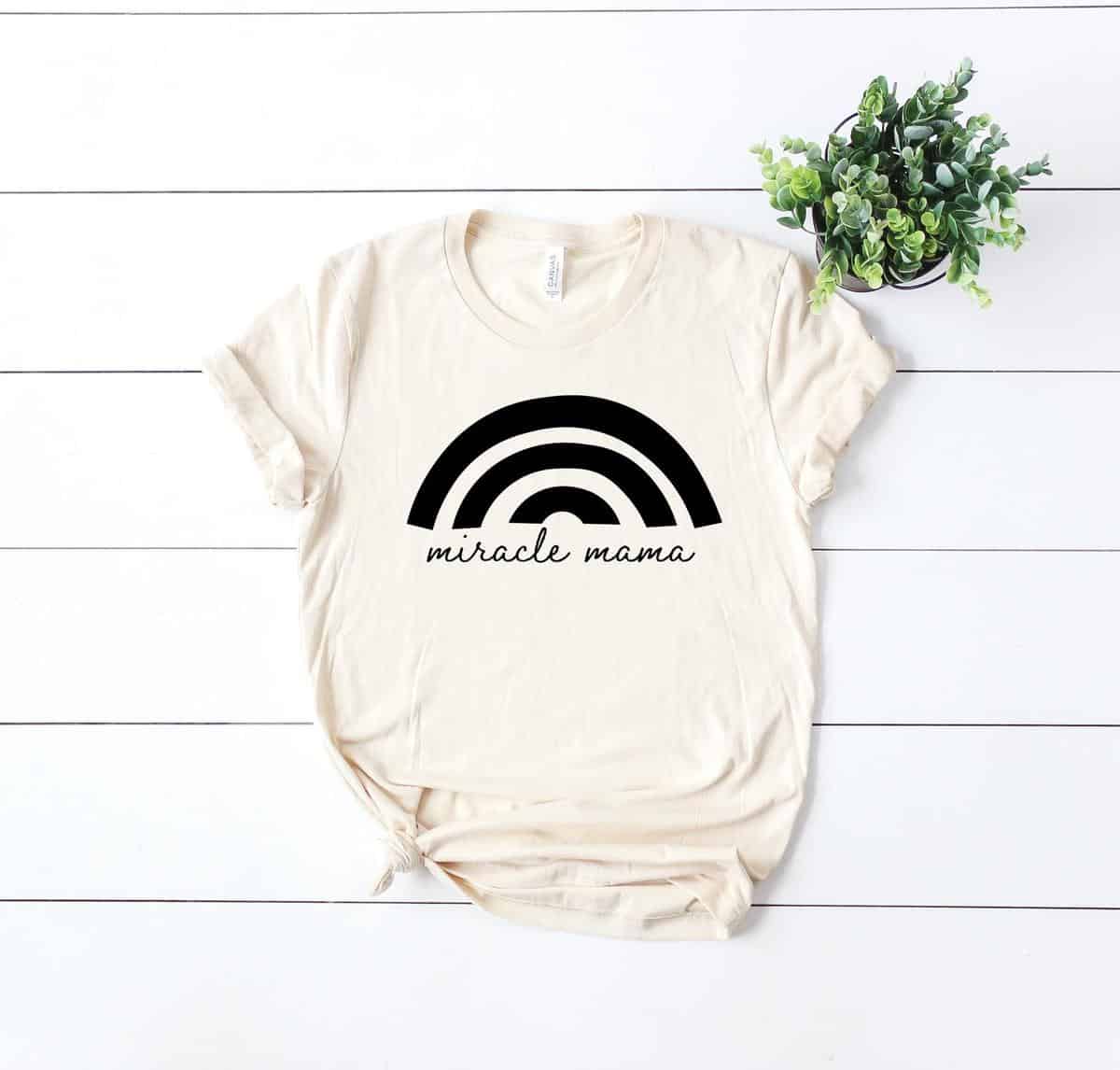 cream-tee-shirt-that-says-miracle-mama-with-rainbow-on-top-this-is-a-great-rainbow-baby-gift