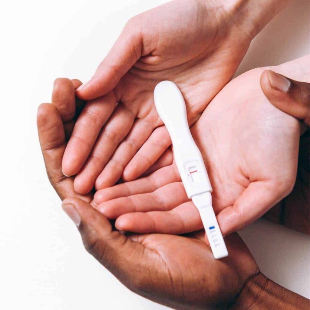 hands holding a pregnancy test