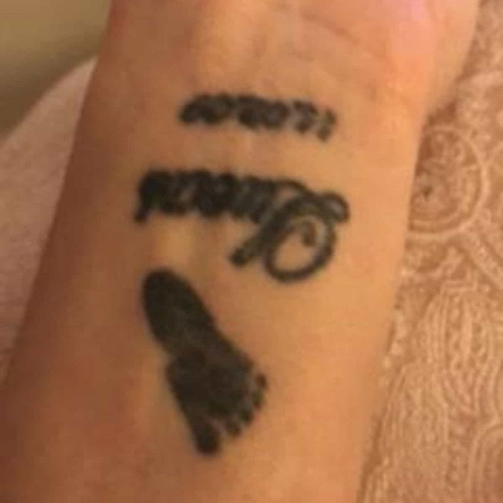 wrist tattoo of baby's footprint