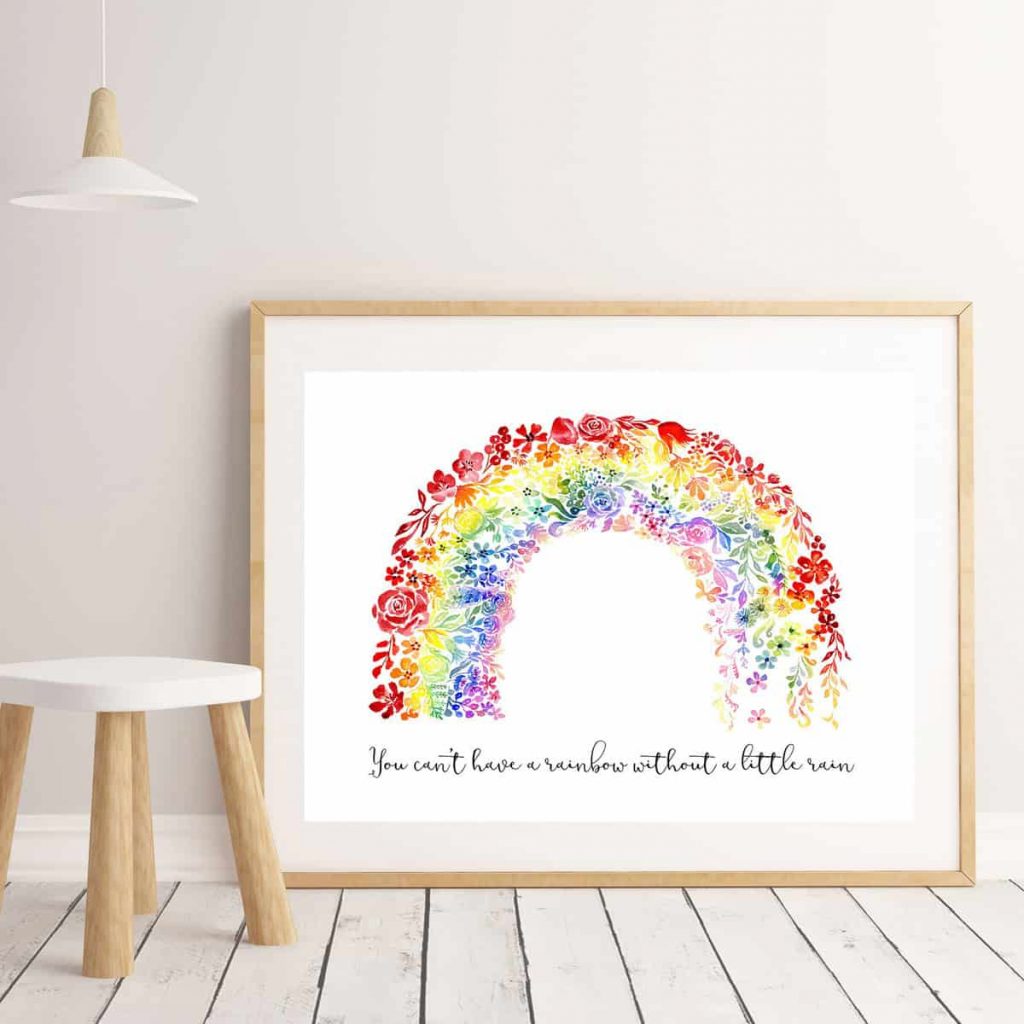 rainbow wall art that looks like painted flowers in the shape and colors of a rainbow with a quote beneath it