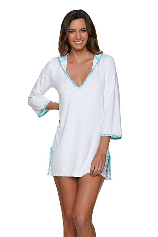 brunette woman poses in white terry cloth swimsuit coverup with blue trime