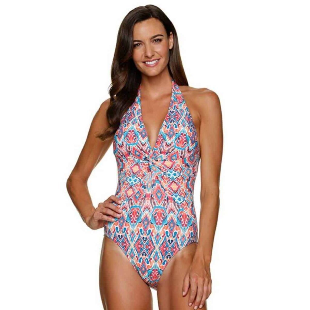 woman in beautiful patterned one-piece swimsuit that twists in the front