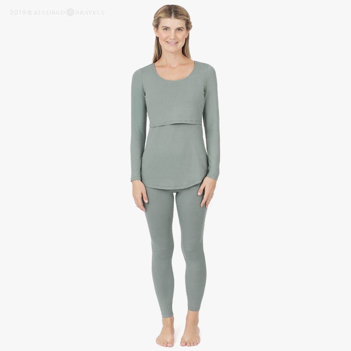 woman wearing green pajamas with an opening designed for breastfeeding