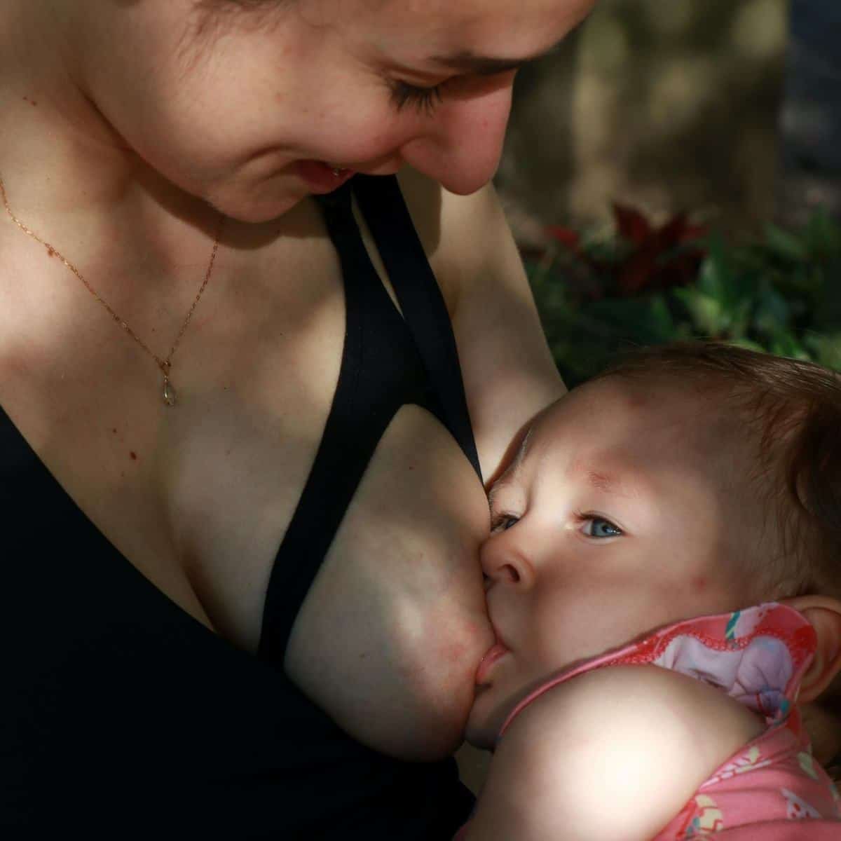 baby is breastfeeding from mother's left breast