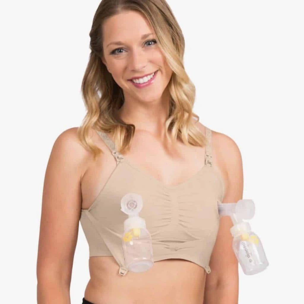 woman wearing bra with breast pumps attached