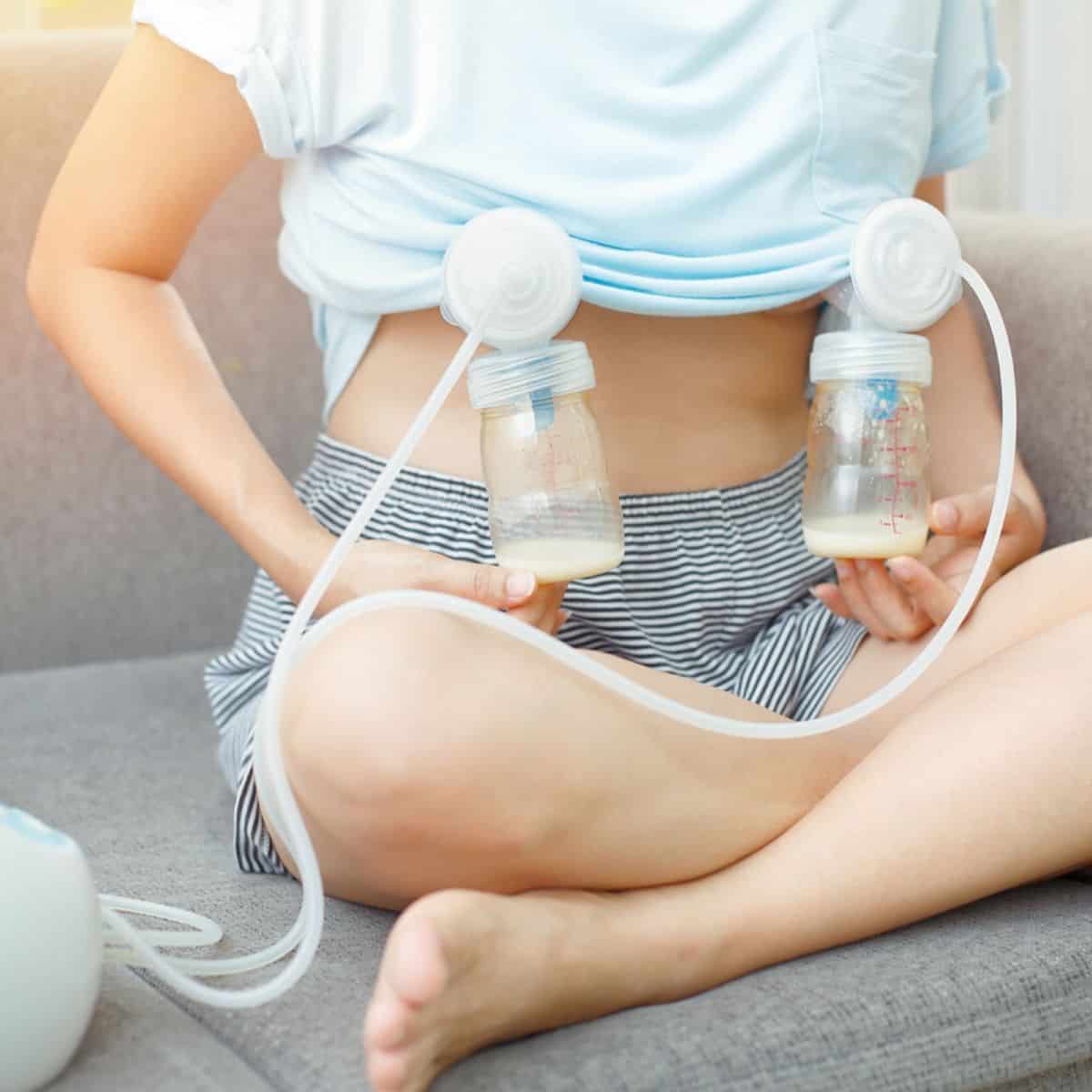 woman holding two breast pumps