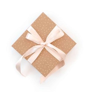 a polka dot gift box with pink ribbon wrapped around it