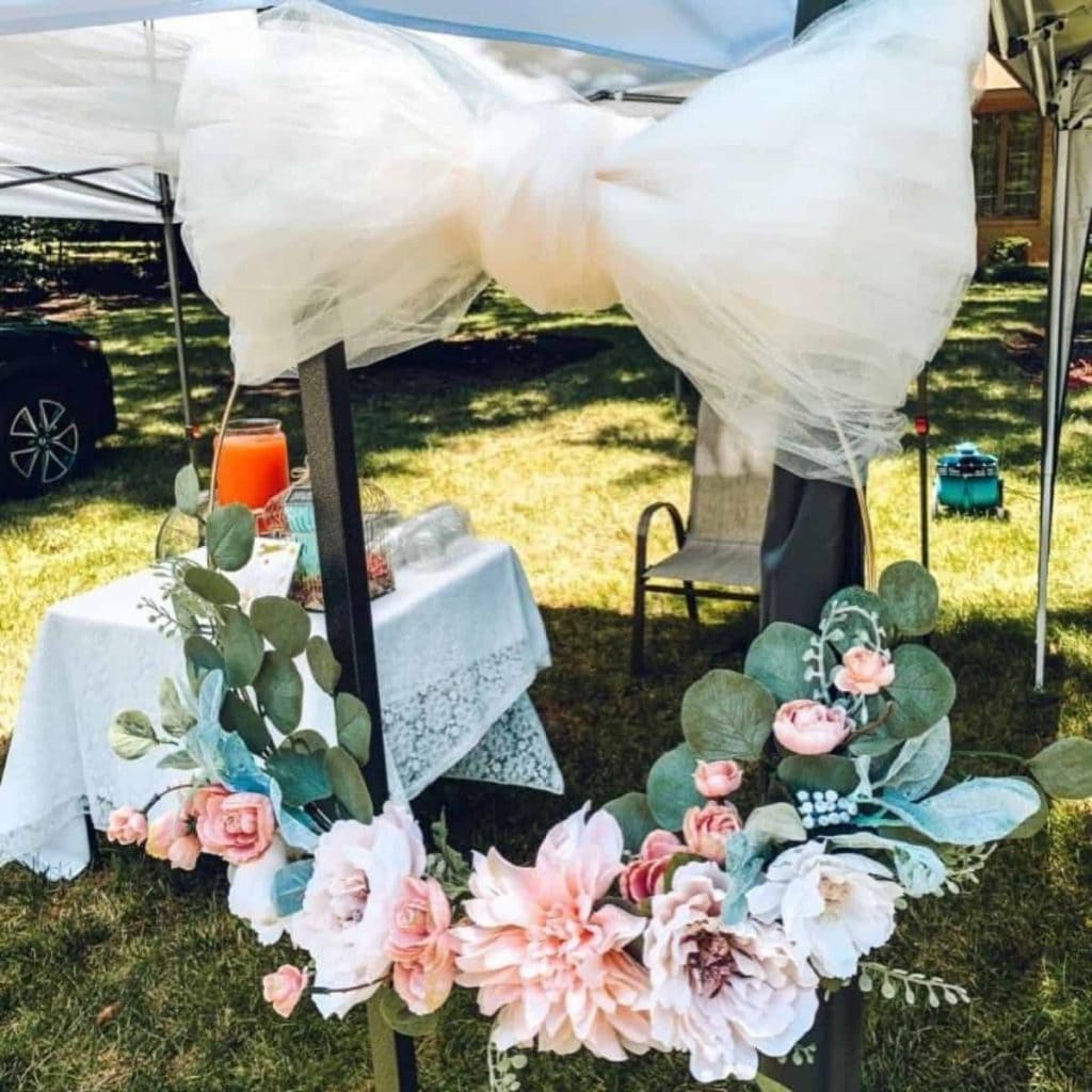 flower wreath hanging on tent as decoration for drive-by baby shower