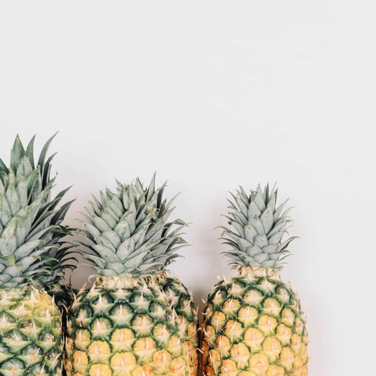 three pineapples laying side by side