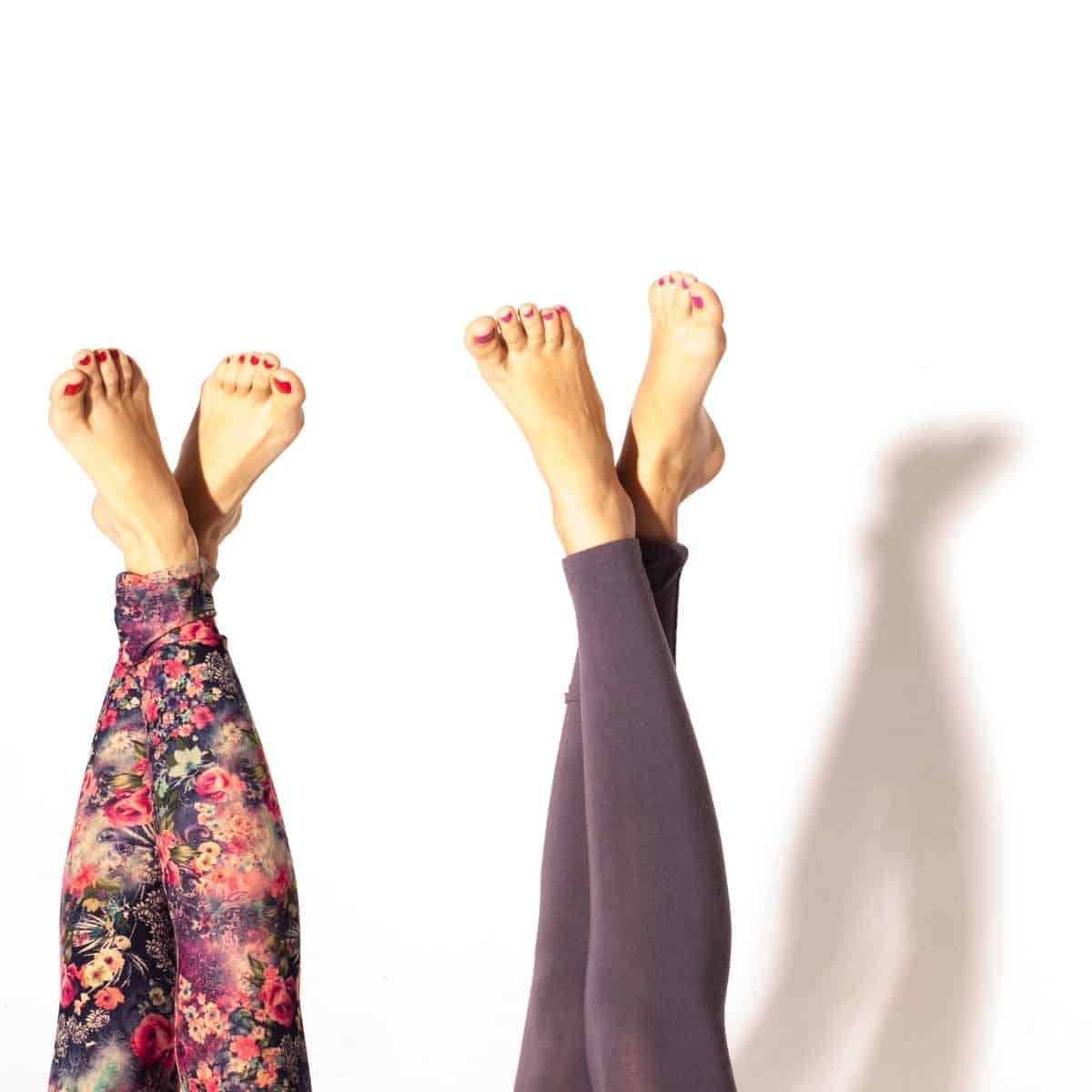 Two feet upside down wearing postpartum leggings.