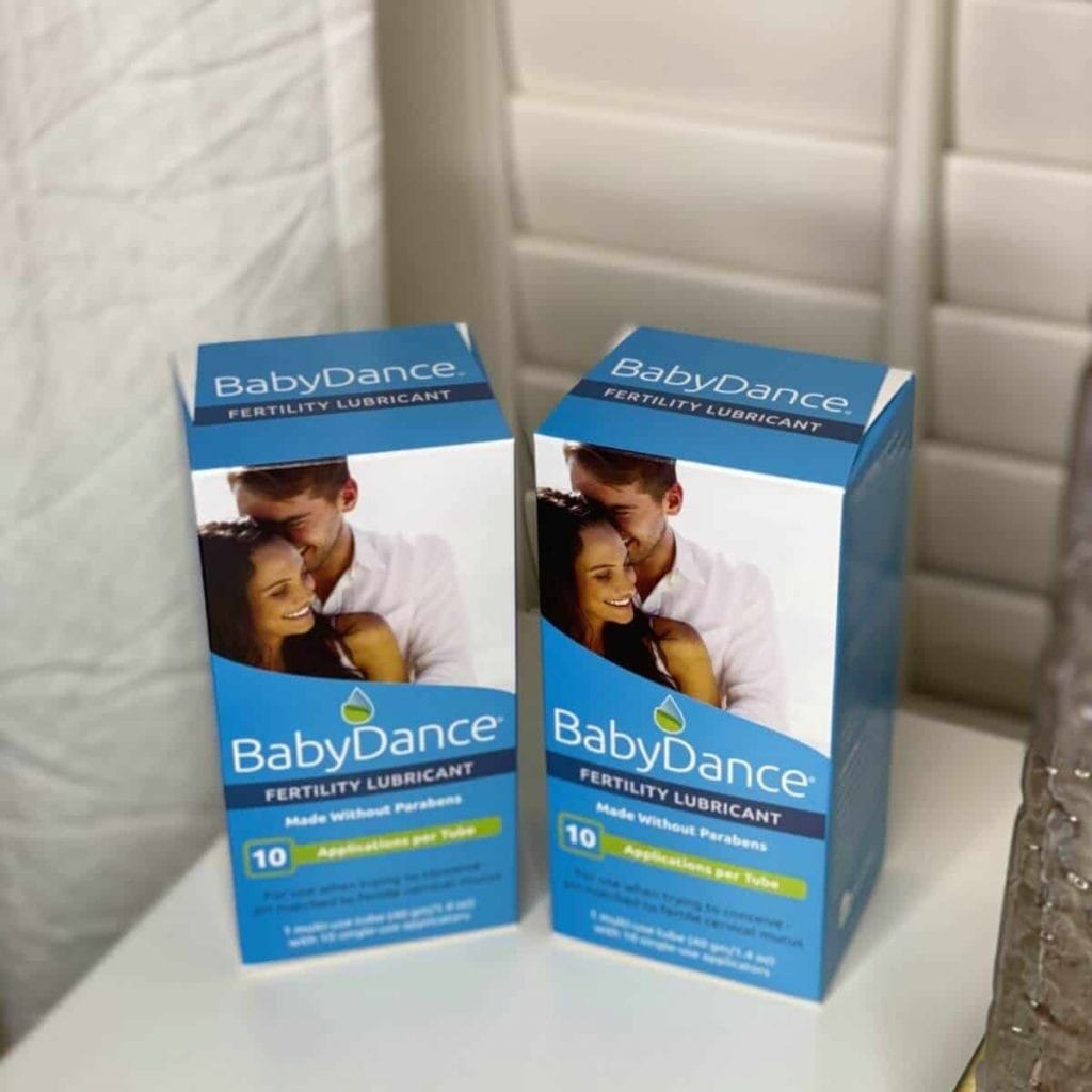 2 boxes of baby dance fertility lubricant by fairhaven health in evening lighting on a nightstand