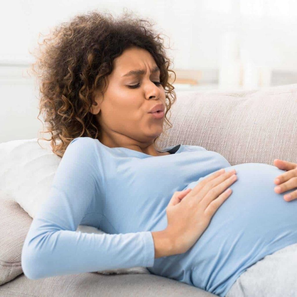 Woman reclines on couch in labor