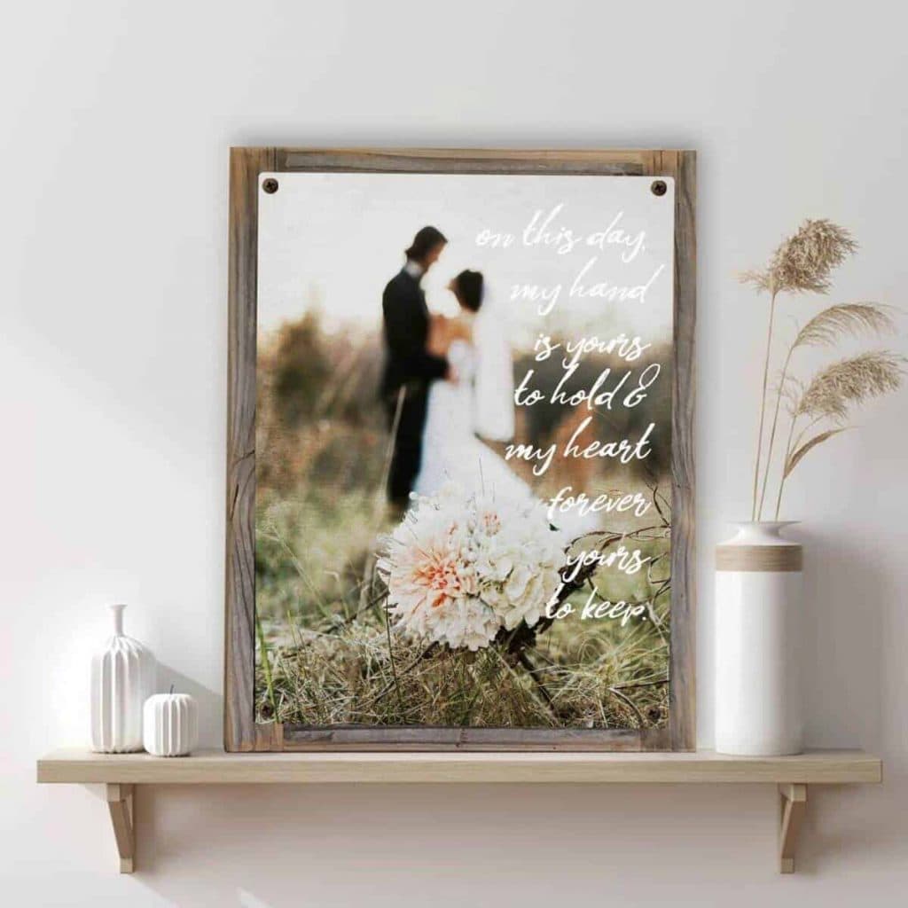 a beautiful wedding photo printed on metal resting on a rustic wooden shelf