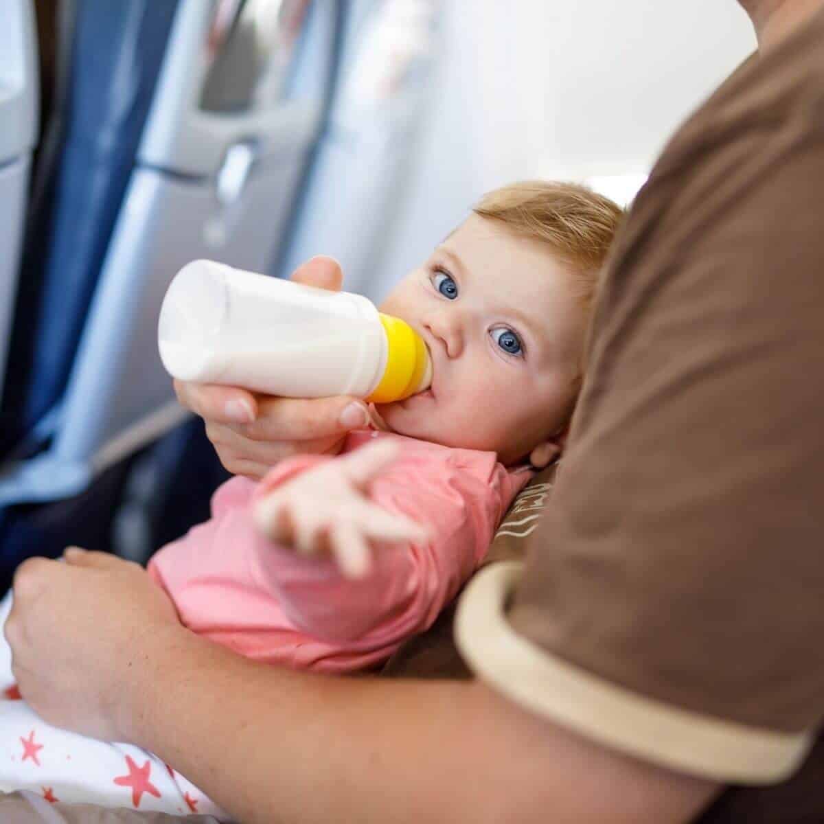 Baby bottle feeding on a plane