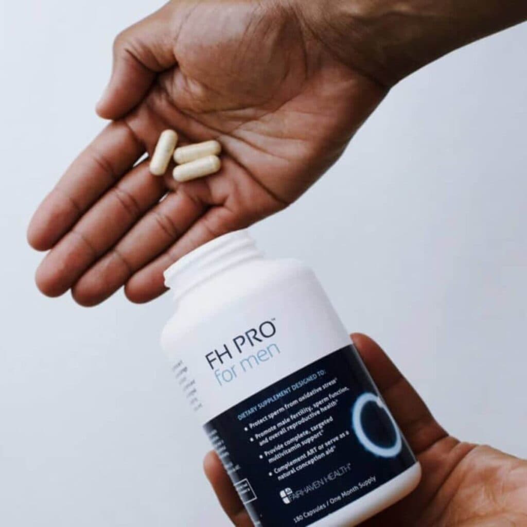 a photo of a man's hands holding up a bottle of FH Pro For Men by Fairhaven Health, with his other hand positioned above the bottom hand, holding some supplements from the container
