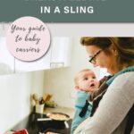 Pinterest Pin that shows a woman smiling down at her baby in a front carrier. The woman is standing in front of a kitchen counter preparing a salad. Text says " How to conquer breastfeeding in a sling: Your guide to baby carriers"